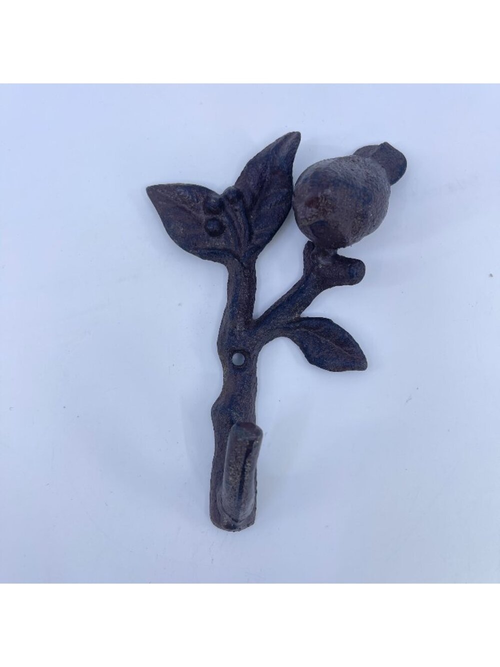 rustic cast iron decorative wall hook with bird perched on leafy branch